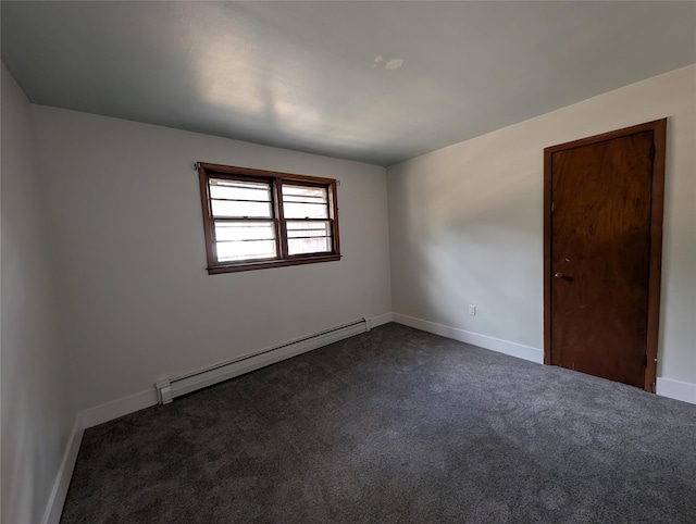 carpeted empty room featuring a baseboard radiator