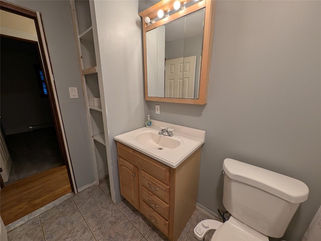 bathroom featuring tile patterned flooring, vanity, and toilet