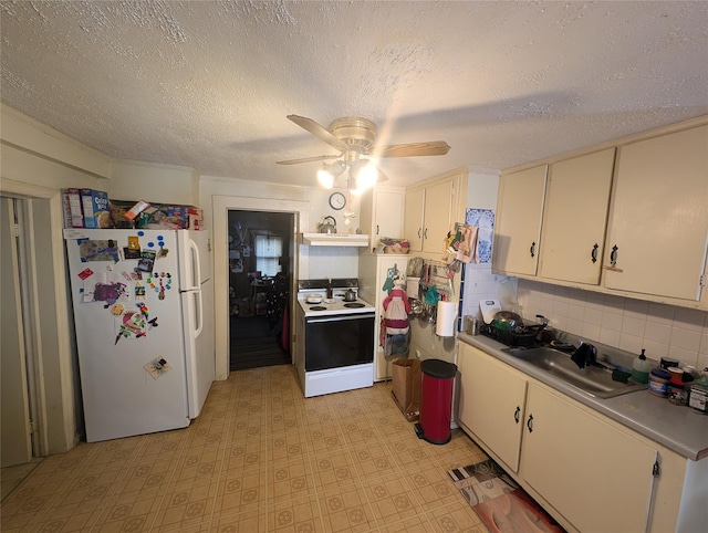 kitchen featuring ceiling fan, sink, white cabinets, and white appliances