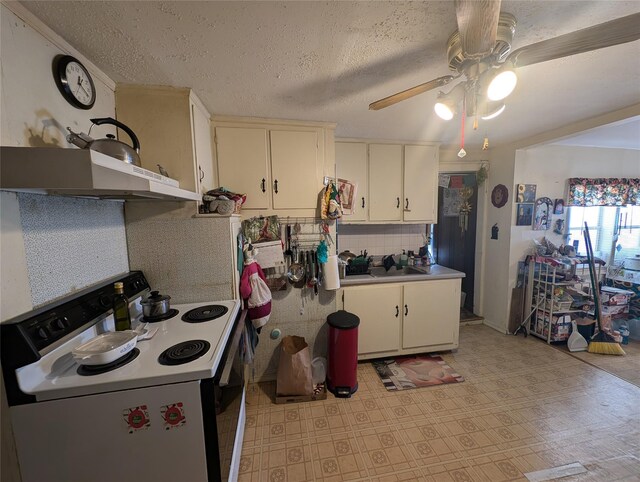 kitchen featuring white cabinetry, white range with electric cooktop, ceiling fan, and sink