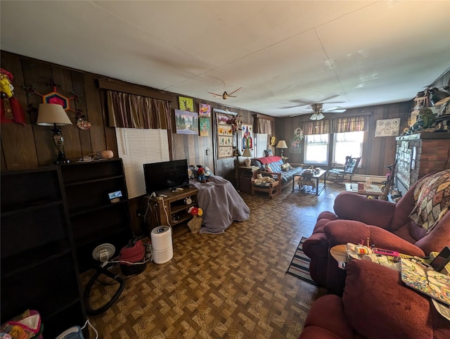 living room featuring parquet flooring, ceiling fan, and wood walls