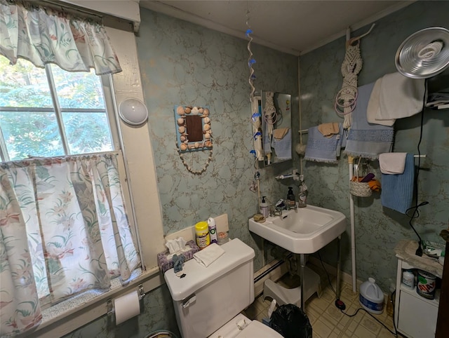 bathroom with baseboard heating, sink, and toilet