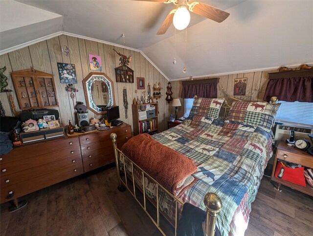 bedroom with wood walls, ceiling fan, dark wood-type flooring, and vaulted ceiling