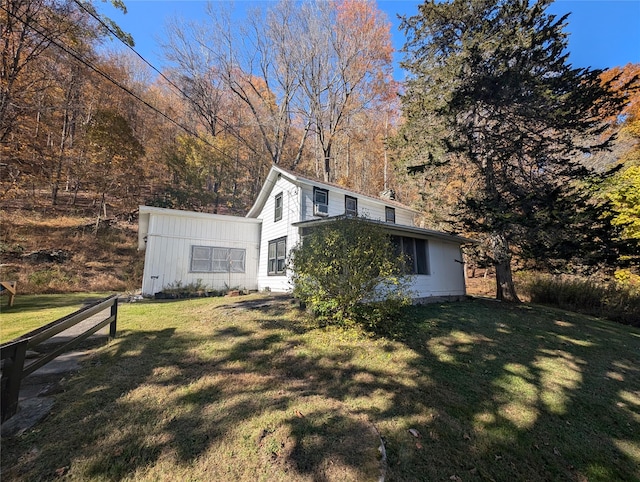 view of side of property featuring a yard