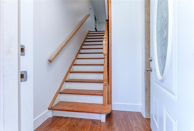 staircase with hardwood / wood-style flooring