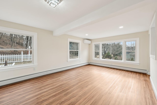 spare room with a wall unit AC, baseboard heating, a baseboard heating unit, wood finished floors, and beamed ceiling