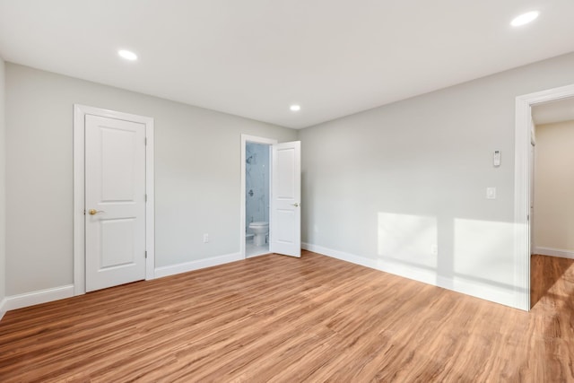 unfurnished room with light wood-style floors, baseboards, and recessed lighting