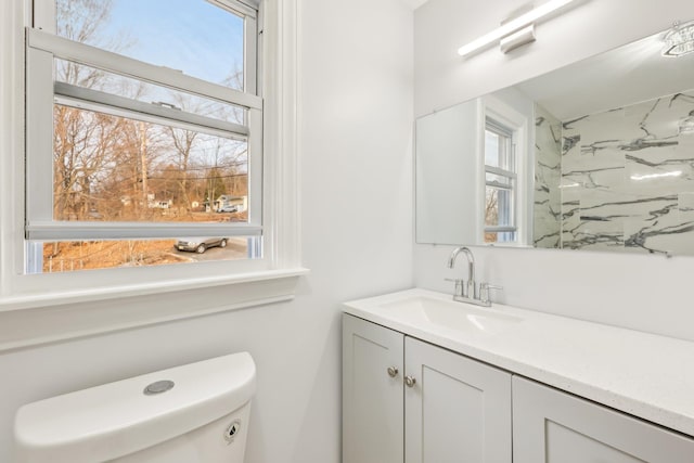 bathroom featuring vanity and toilet