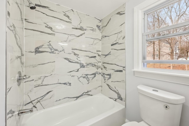 bathroom featuring tub / shower combination, toilet, and a healthy amount of sunlight