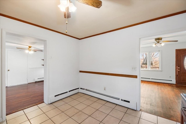 unfurnished room featuring ornamental molding, a baseboard radiator, and light hardwood / wood-style floors