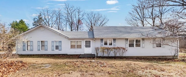 rear view of property with a yard