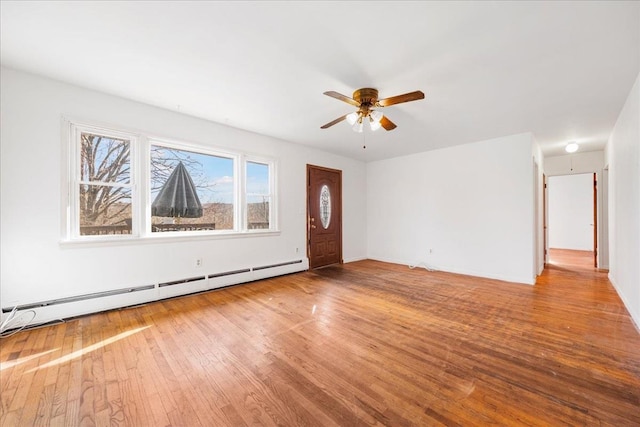 unfurnished living room featuring ceiling fan, a baseboard radiator, and wood-type flooring