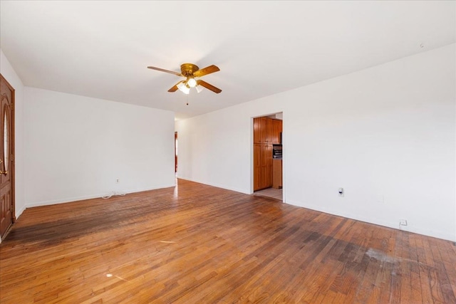 empty room with ceiling fan and light wood-type flooring