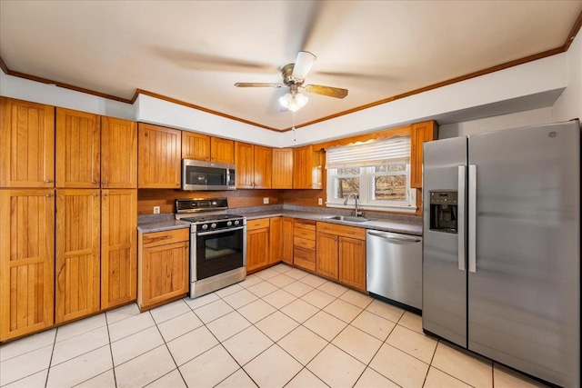 kitchen featuring sink, ceiling fan, light tile patterned floors, ornamental molding, and appliances with stainless steel finishes