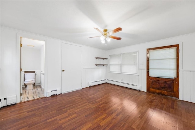 unfurnished bedroom with ensuite bath, ceiling fan, a baseboard radiator, crown molding, and wood-type flooring