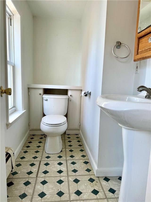 bathroom featuring toilet and a baseboard radiator