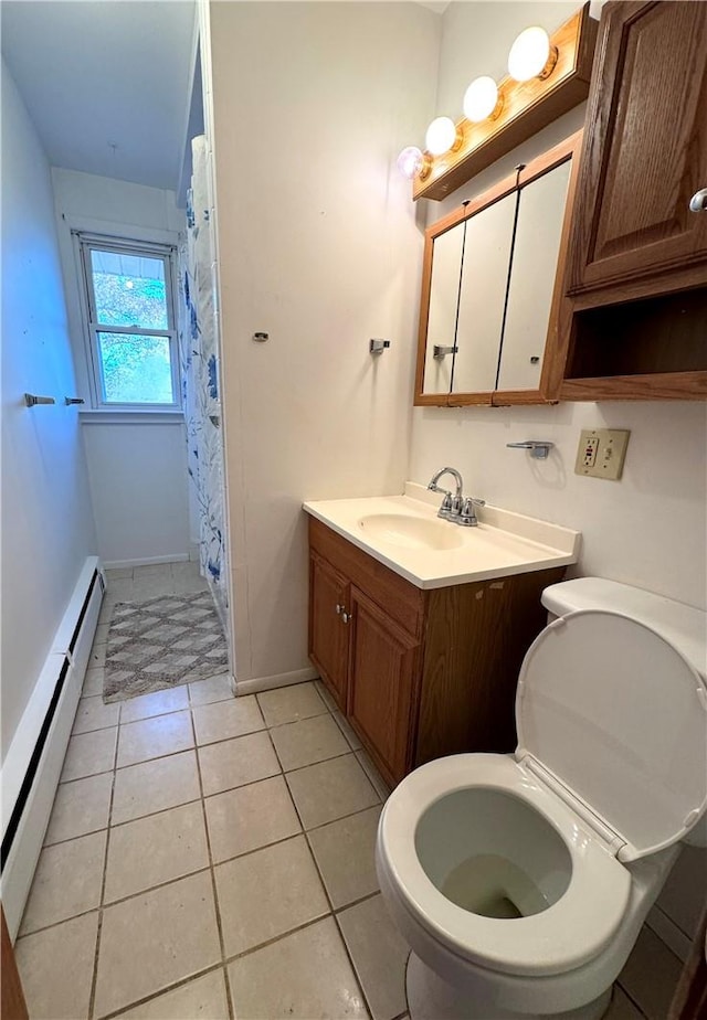 bathroom featuring tile patterned flooring, vanity, toilet, and baseboard heating