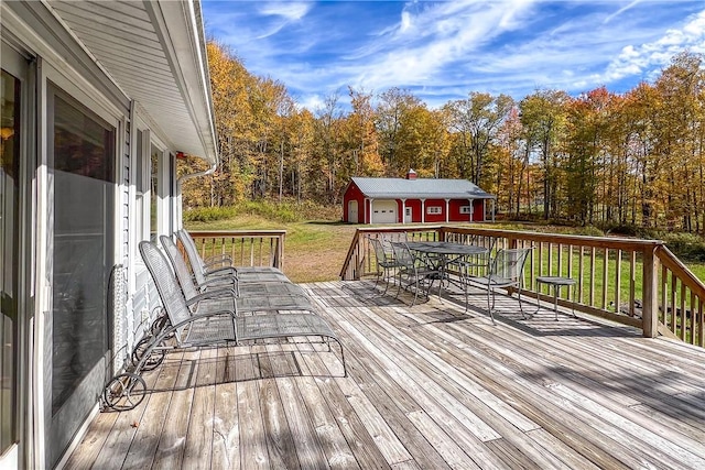 deck featuring an outdoor structure and a yard