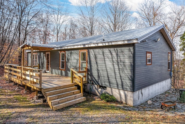 back of property with a wooden deck