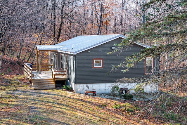 view of home's exterior with a wooden deck