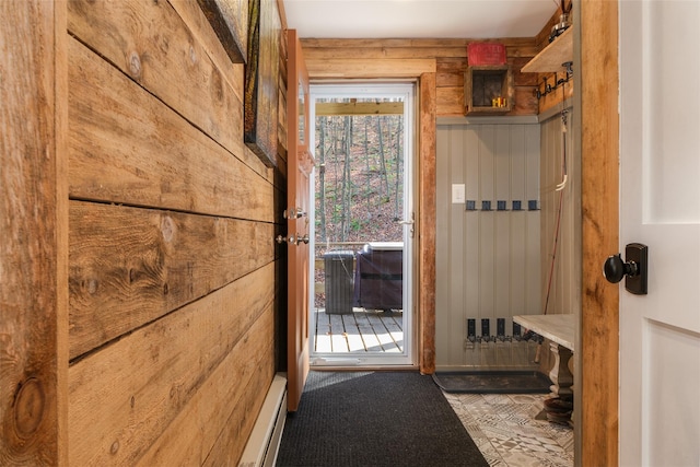 mudroom featuring a baseboard radiator and wood walls