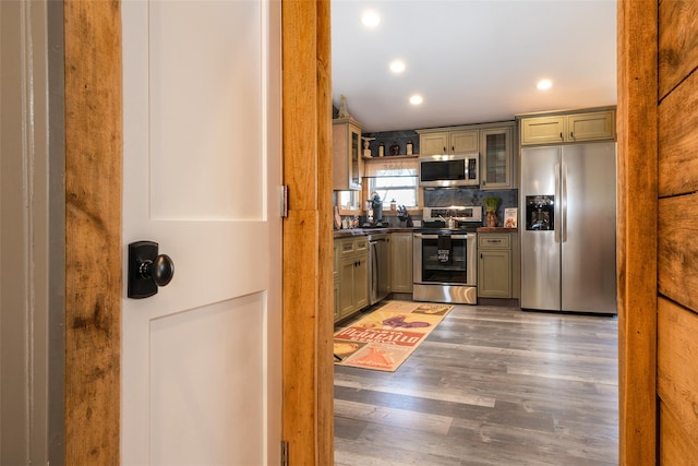 kitchen with decorative backsplash, dark hardwood / wood-style flooring, and appliances with stainless steel finishes