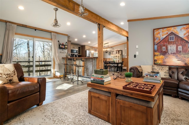 living room featuring vaulted ceiling, crown molding, a baseboard radiator, light hardwood / wood-style flooring, and a notable chandelier