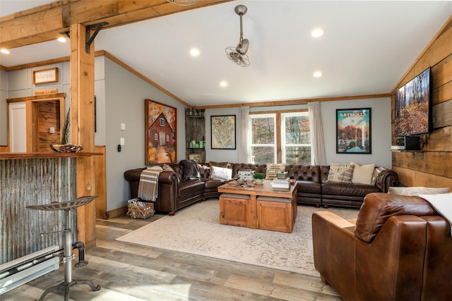 living room with vaulted ceiling, ornamental molding, and light hardwood / wood-style flooring