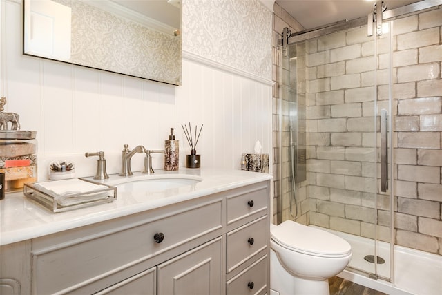 bathroom featuring hardwood / wood-style floors, vanity, toilet, and a shower with shower door