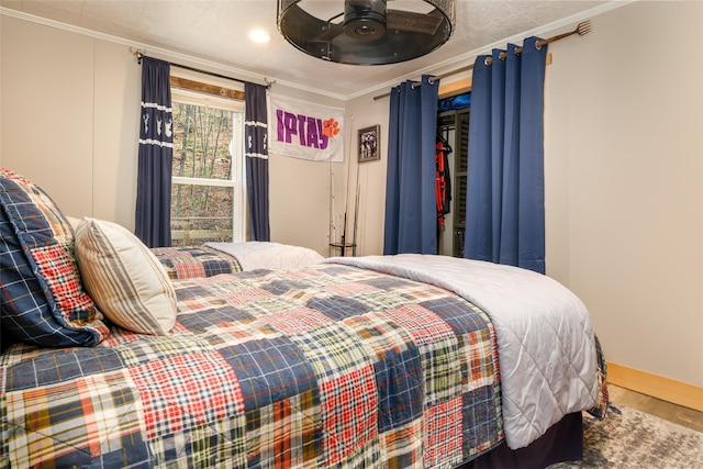 bedroom with wood-type flooring, ceiling fan, and ornamental molding