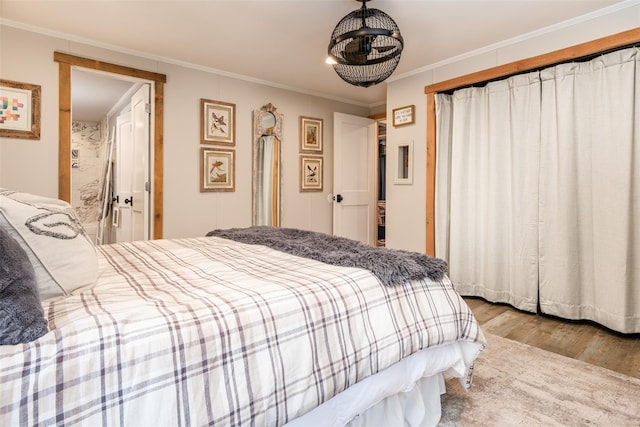 bedroom featuring light hardwood / wood-style floors and crown molding