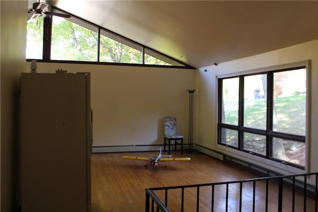 empty room featuring ceiling fan, hardwood / wood-style floors, and vaulted ceiling