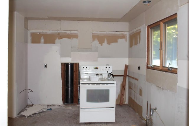 kitchen featuring light countertops and white range with electric cooktop