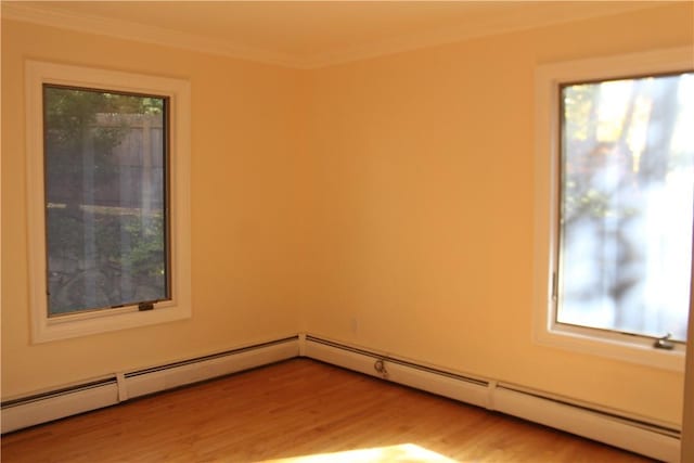 unfurnished room featuring a wealth of natural light, ornamental molding, and light wood-type flooring