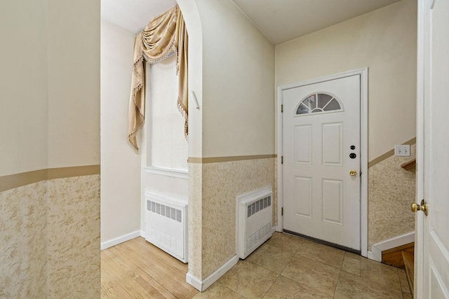 foyer featuring wood-type flooring and radiator