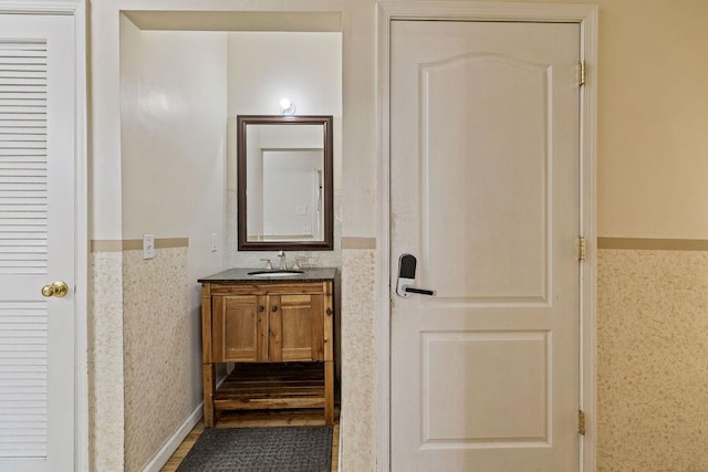 bathroom featuring vanity and tile walls