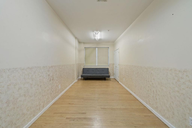 corridor with hardwood / wood-style floors