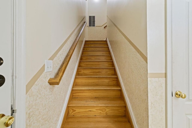 staircase with hardwood / wood-style flooring