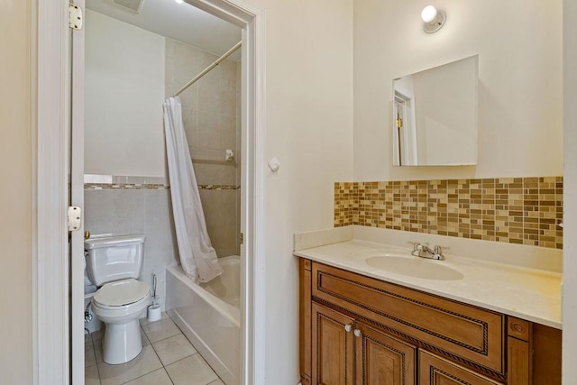 full bathroom featuring vanity, tile patterned flooring, toilet, shower / bath combo with shower curtain, and tile walls