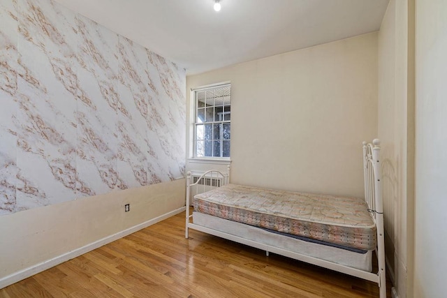 unfurnished bedroom with hardwood / wood-style floors