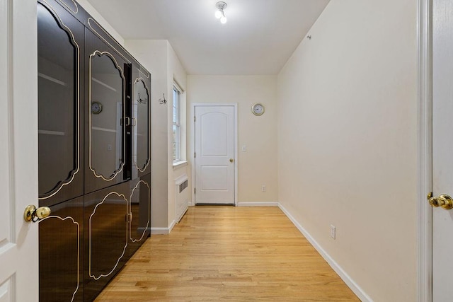 corridor featuring washer and dryer and light wood-type flooring