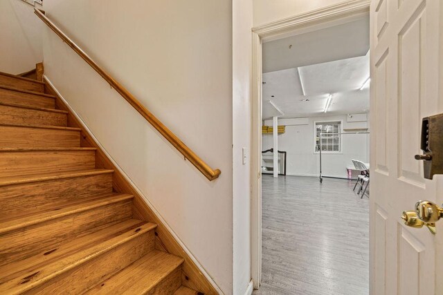 stairs featuring hardwood / wood-style floors