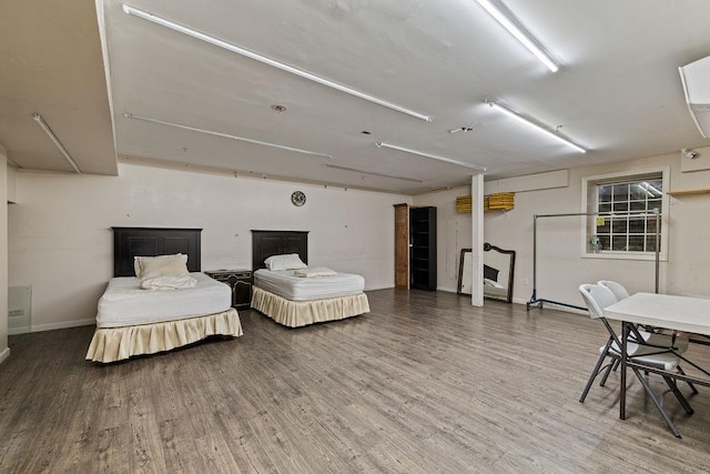 bedroom with dark hardwood / wood-style flooring