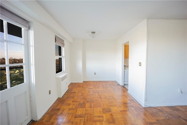 corridor with radiator and light parquet floors