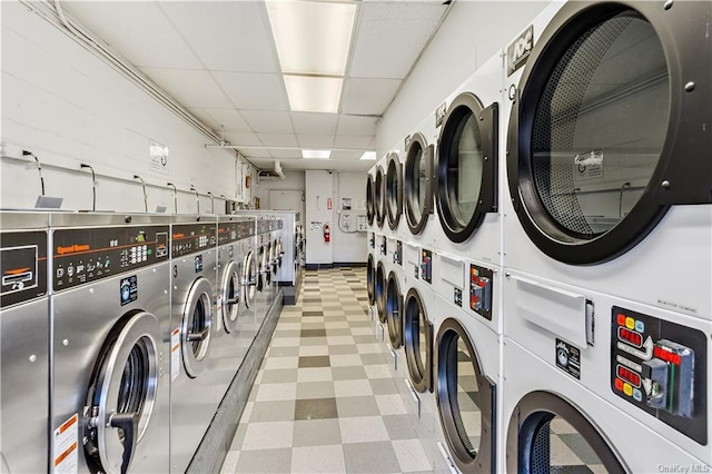 laundry room with stacked washer and dryer and washing machine and clothes dryer