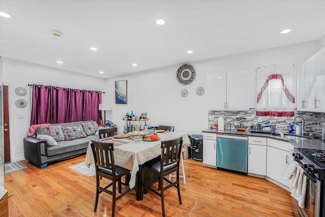 dining area with light wood-type flooring and sink