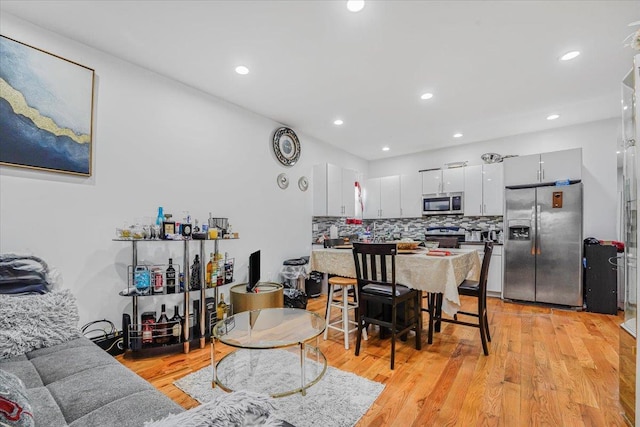 dining space with light hardwood / wood-style floors