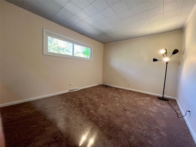 carpeted empty room featuring crown molding