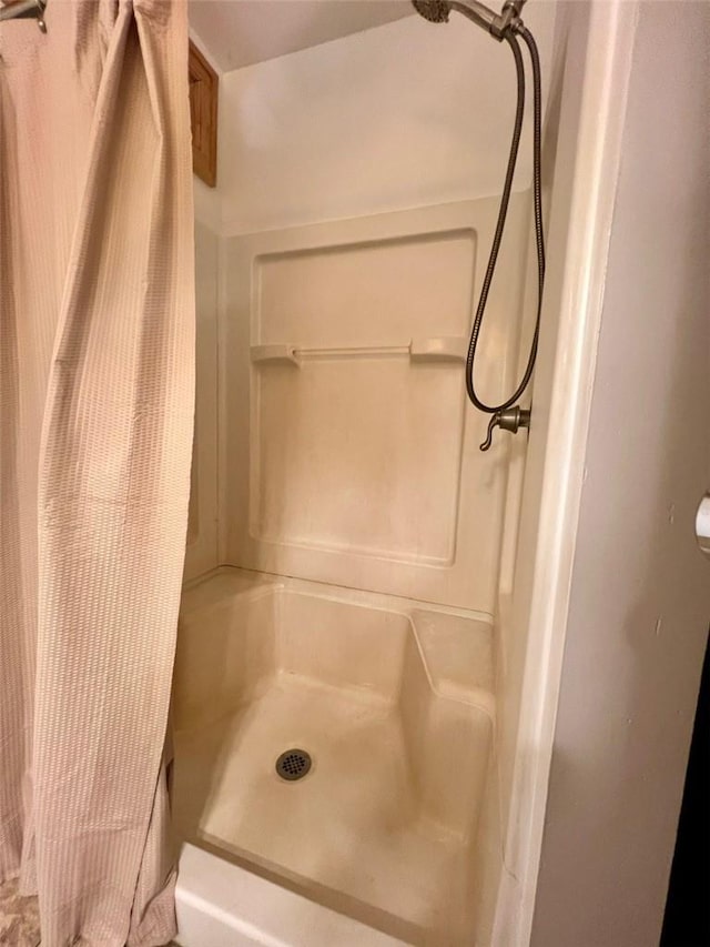 bathroom with a shower with shower curtain