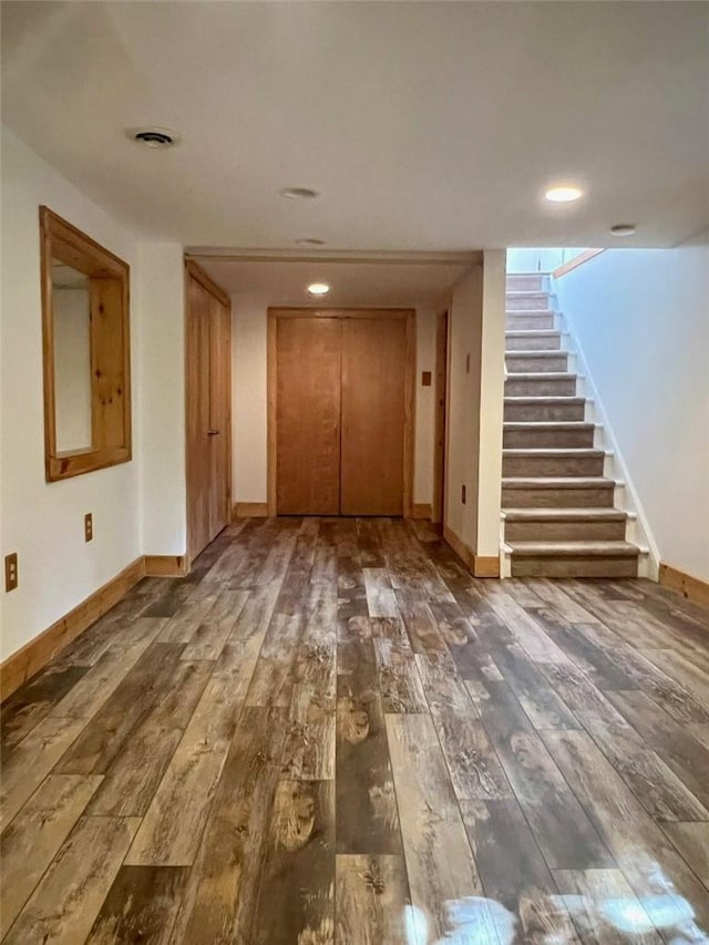 interior space with dark wood-type flooring and elevator